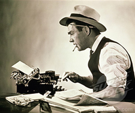 Side profile of a journalist typing on a typewriter