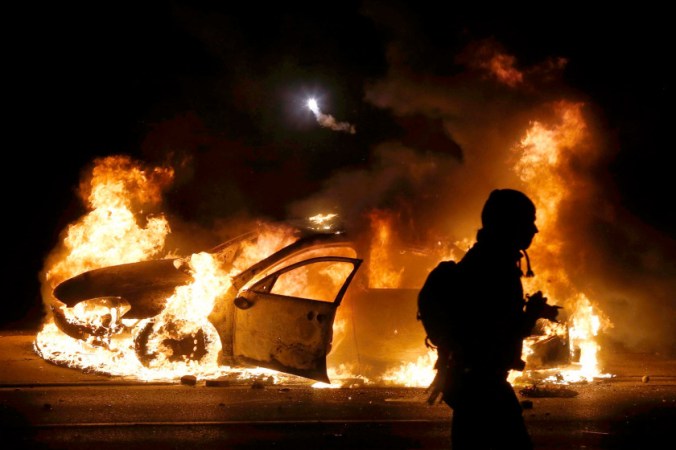 A car burns on the street after a grand jury returned no indictment in the shooting of Michael Brown in Ferguson, Missouri