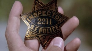 This is Dirt Harry's badge. Seconds later, he throws it into a river. Lots of other police will be doing the same.