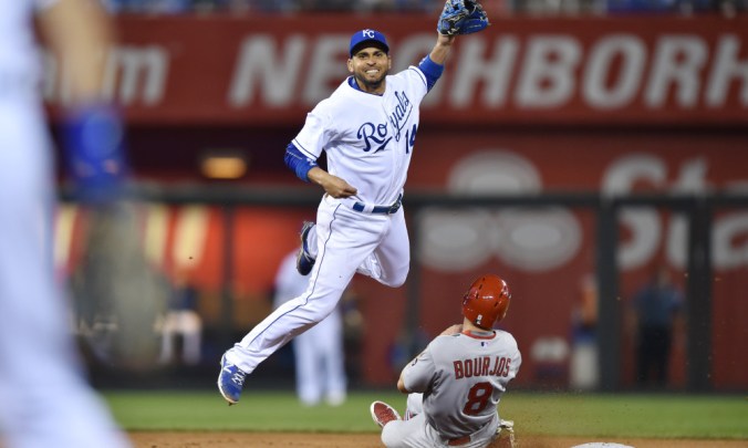 May 22, 2015; Kansas City, MO, USA; Kansas City Royals second basemen Omar Infante (14) attempts a throw to first over St. Louis Cardinals base runner Peter Bourjos (8) during the seventh inning at Kauffman Stadium. Mandatory Credit: Peter G. Aiken-USA TODAY Sports