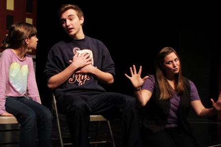 Gavin Alvedy rehearses a scene from the Downriver Youth Performing Arts Center's "Miracle on 34th Street" as DYPAC alum Emily Zaleski signs alongside him. Zaleski, who grew up performing on DYPAC’s stage, now is a certified American Sign Language interpreter with Synergy on Stage and will interpret during the Dec. 8 performance.