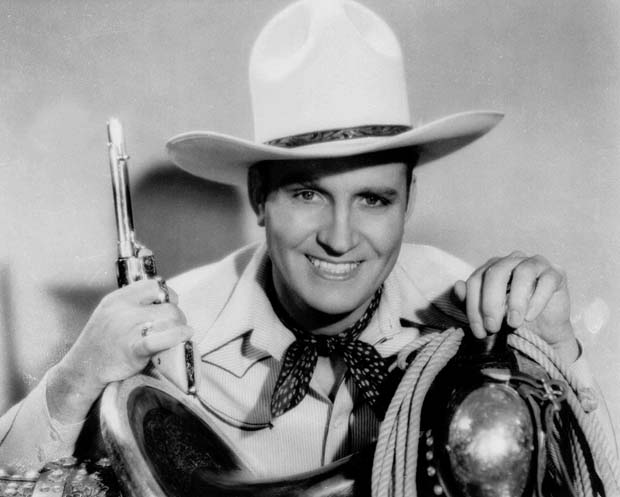 ORG XMIT: NY21 Singing cowboy star Gene Autry is shown in an undated file photo. Autry, who parlayed a $5 mail order guitar into a career as Hollywood's first singing cowboy, died Friday, Oct. 2, 1998. He was 91. His death came less than three months after the death of his great rival, Roy Rogers.