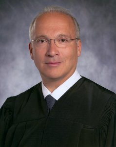 Judge Curial. Funny, he looks white to me...